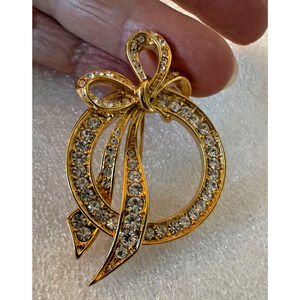 Vintage NOLAN MILLER Circle Pin Gold Tone Bow Clear Rhinestones Wedding 2"